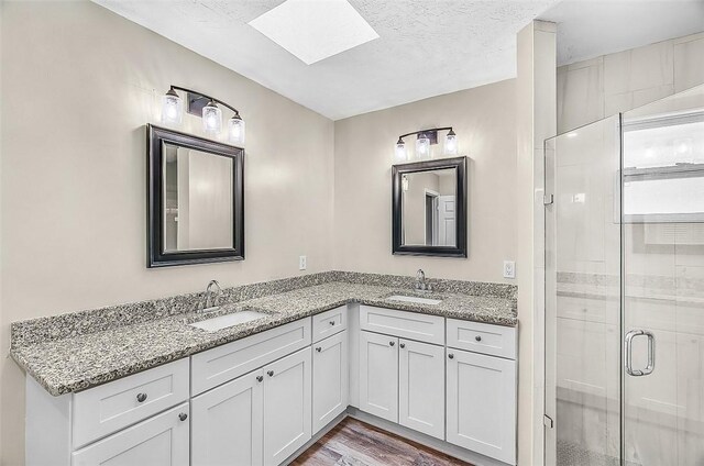 435 61st Ave, Vero Beach, FL 32968 - full bath with a skylight, double vanity, a stall shower, and wood finished floors