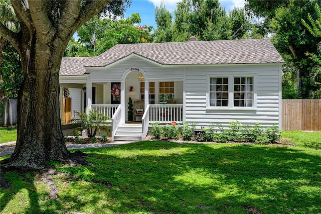 ranch-style home featuring a porch and a front lawn