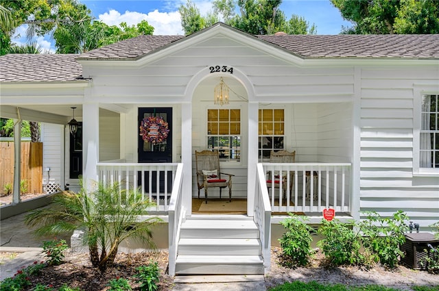 view of exterior entry featuring a porch