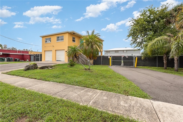 view of front facade with a garage and a front lawn