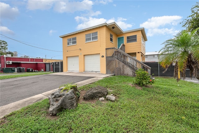 view of front of property featuring a front lawn and a garage