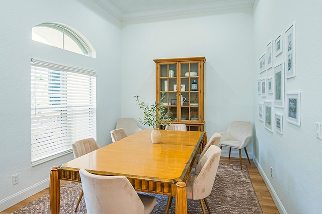 dining room featuring hardwood / wood-style flooring and crown molding