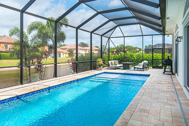 view of pool with a patio, outdoor lounge area, and a lanai