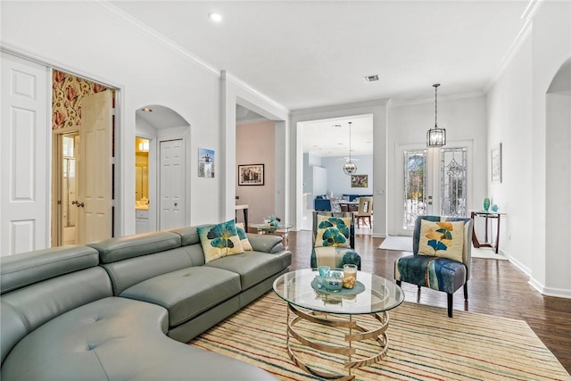 919 Island Club Sq, Vero Beach, FL 32963 - living room featuring visible vents, crown molding, arched walkways, baseboards, and dark wood-style floors
