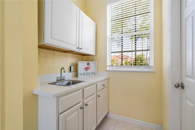 919 Island Club Sq, Vero Beach, FL 32963 - washroom featuring baseboards, a sink, and light tile patterned floors