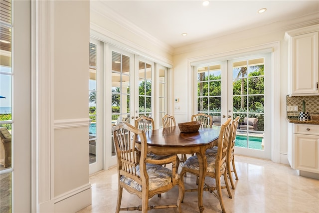 dining area with ornamental molding and french doors