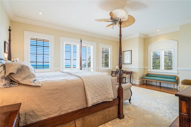 bedroom featuring crown molding, ceiling fan, and light hardwood / wood-style flooring