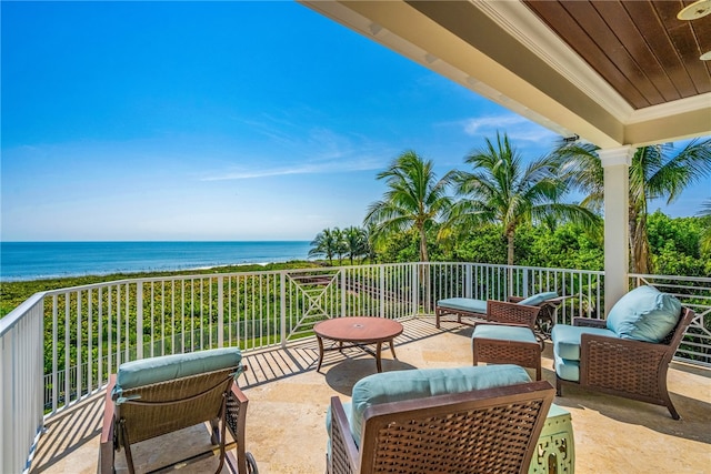 view of patio / terrace with a water view, a balcony, a beach view, and an outdoor hangout area