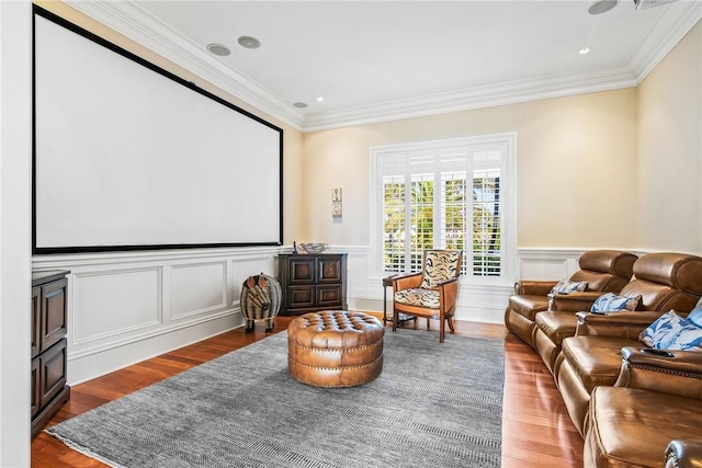 cinema room with crown molding and wood-type flooring