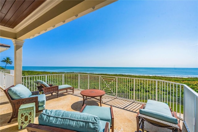 balcony featuring an outdoor living space and a water view