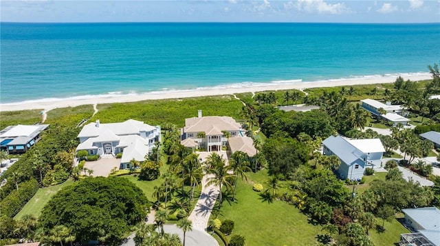 drone / aerial view featuring a water view and a beach view