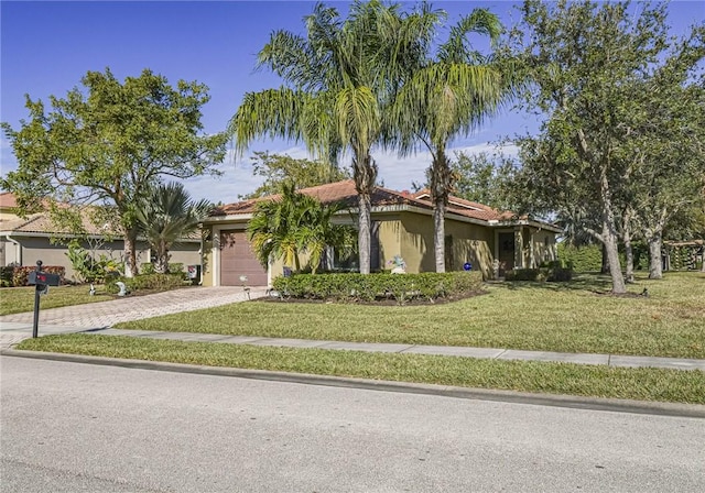 view of front of home featuring a garage and a front yard