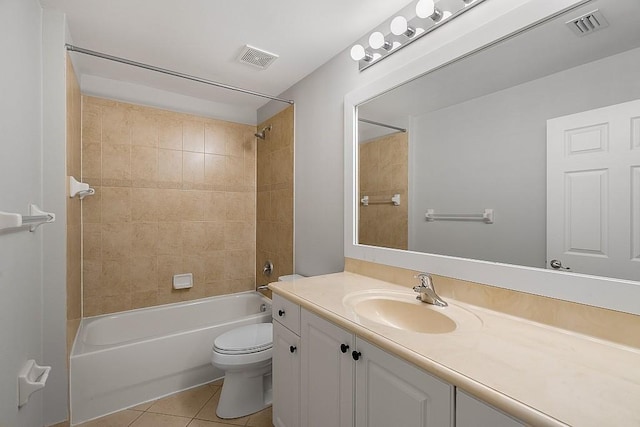 full bathroom with toilet, vanity, tiled shower / bath, and tile patterned flooring