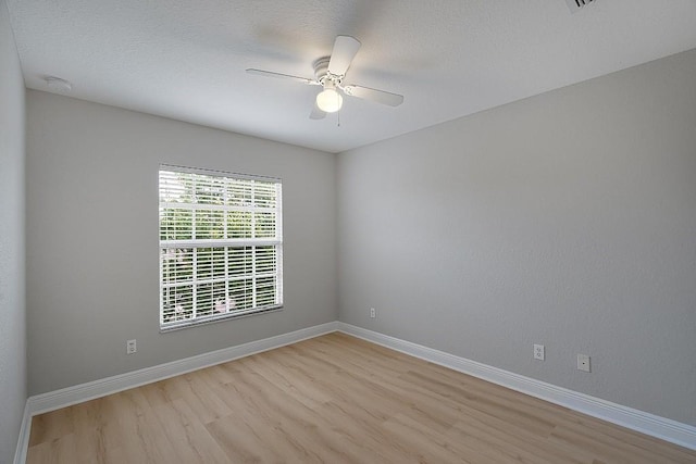 spare room with ceiling fan and light hardwood / wood-style floors