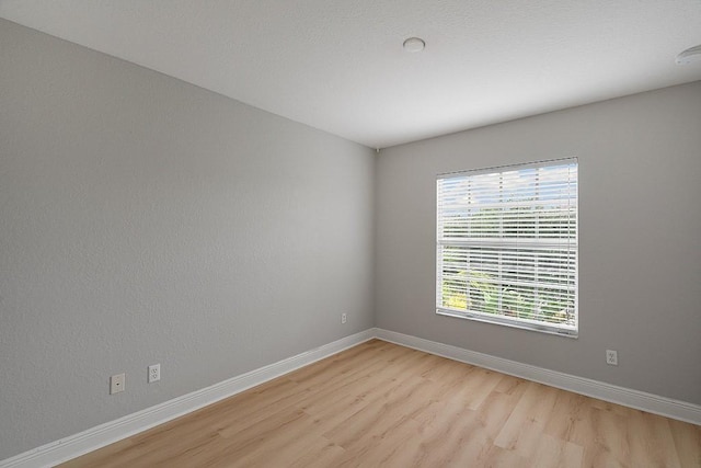 spare room featuring light hardwood / wood-style flooring