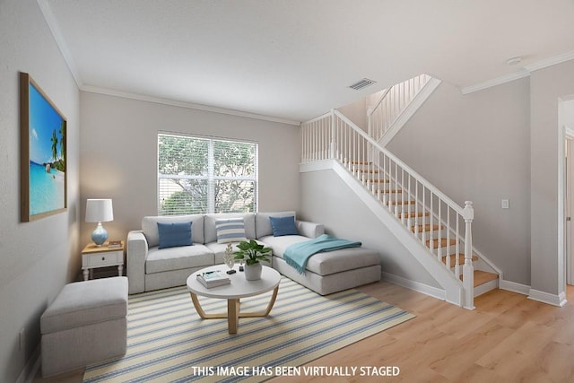 living room with crown molding and light hardwood / wood-style floors