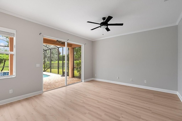 empty room with plenty of natural light, crown molding, and light hardwood / wood-style flooring