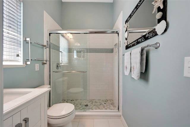 bathroom featuring vanity, tile patterned floors, toilet, and an enclosed shower