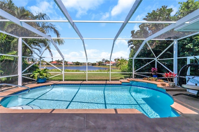 view of pool with a lanai, a water view, and a patio area