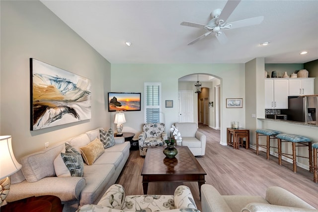 living room featuring ceiling fan and light hardwood / wood-style floors