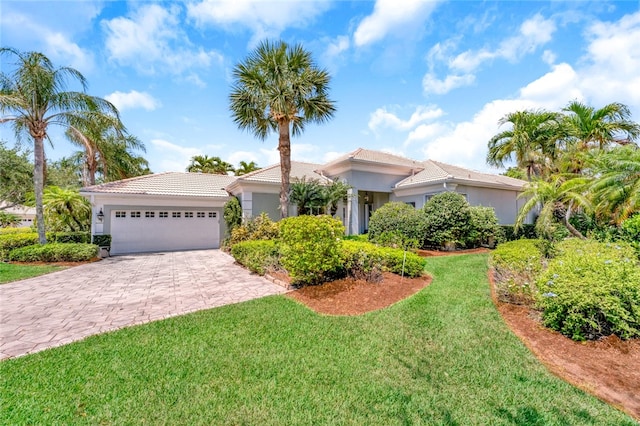 view of front of home featuring a garage and a front lawn