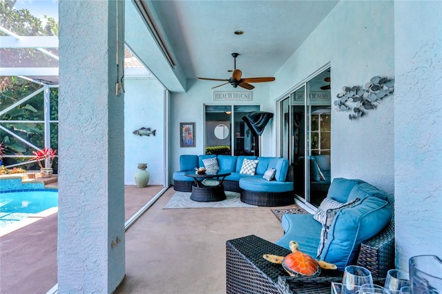 view of patio with outdoor lounge area, glass enclosure, and ceiling fan