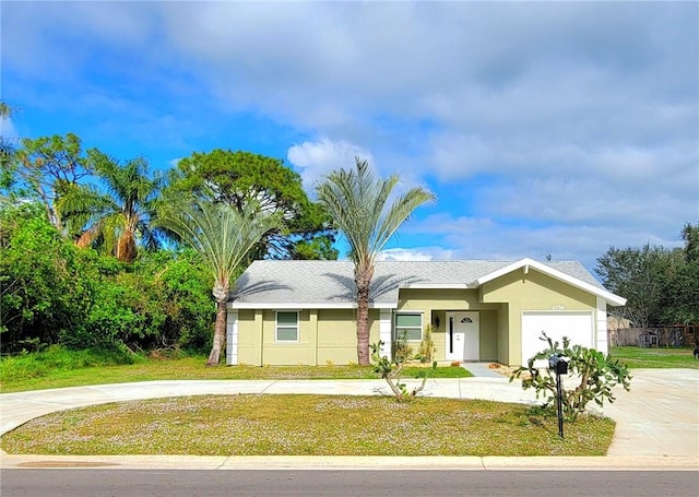 ranch-style house featuring a garage and a front lawn