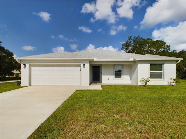 single story home featuring a garage and a front lawn