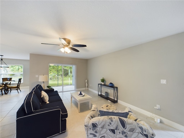 living room with ceiling fan, a healthy amount of sunlight, and light tile patterned floors