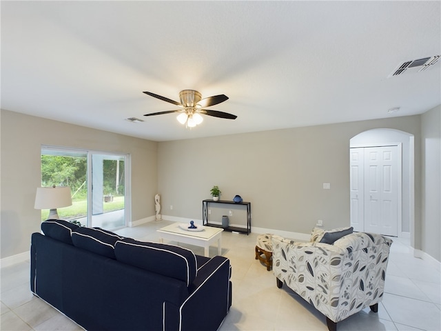 tiled living room with ceiling fan