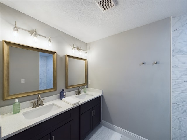 bathroom with vanity and a textured ceiling