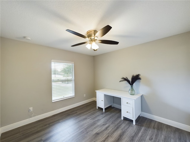 unfurnished office featuring a textured ceiling, dark hardwood / wood-style flooring, and ceiling fan