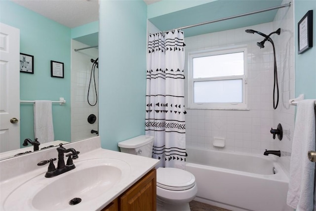 full bathroom with vanity, shower / tub combo, and toilet