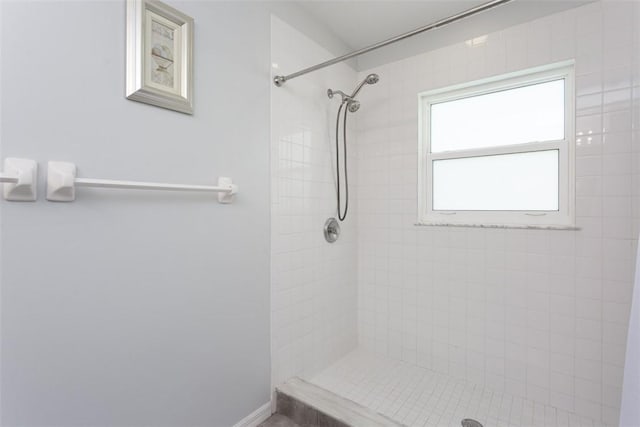 bathroom with a tile shower