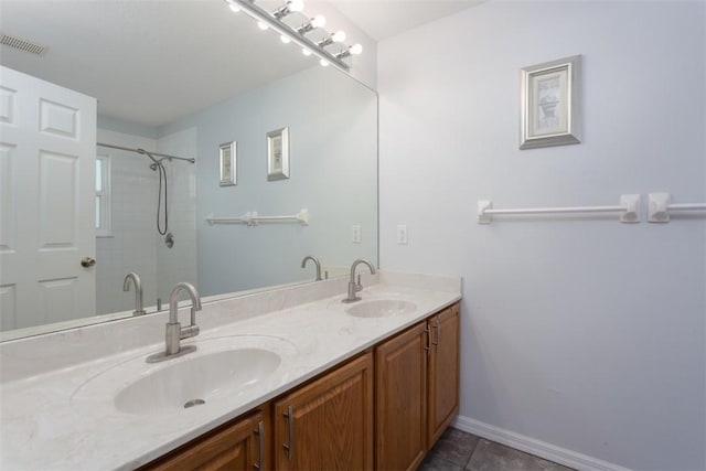 bathroom featuring vanity and tiled shower