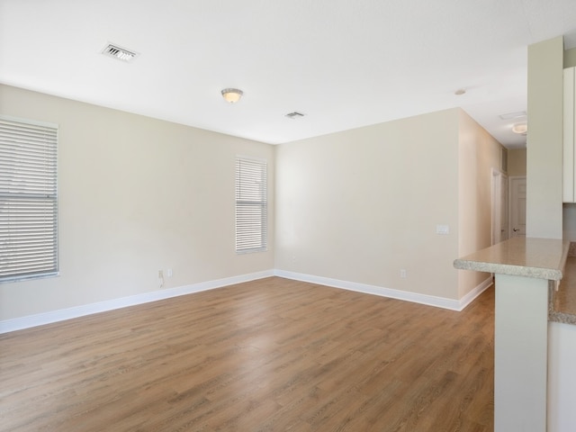 spare room with hardwood / wood-style floors