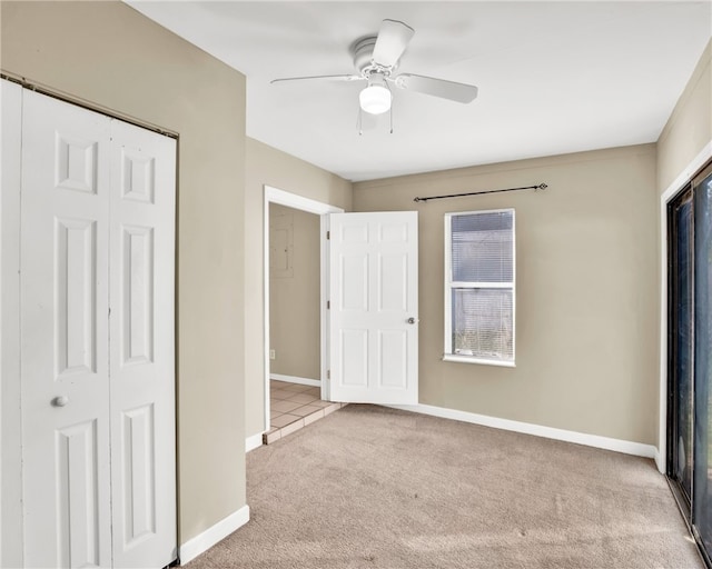 unfurnished bedroom with light carpet, a closet, and ceiling fan