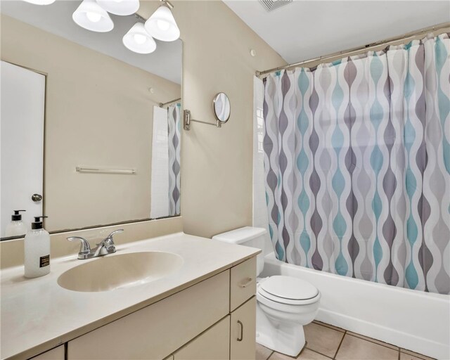 full bathroom with toilet, vanity, tile patterned floors, and shower / bathtub combination with curtain