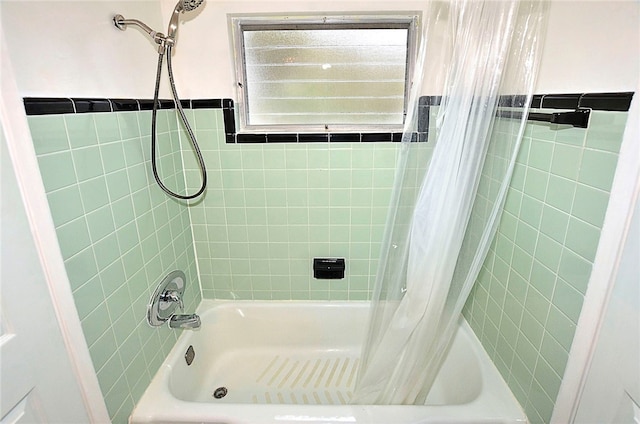 bathroom with shower / tub combo with curtain