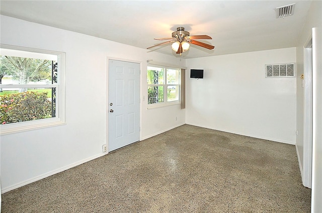 unfurnished room featuring ceiling fan and a healthy amount of sunlight