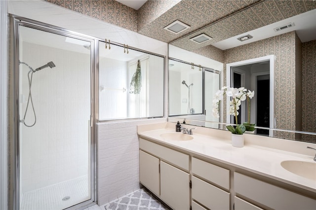 bathroom with vanity and a shower with shower door