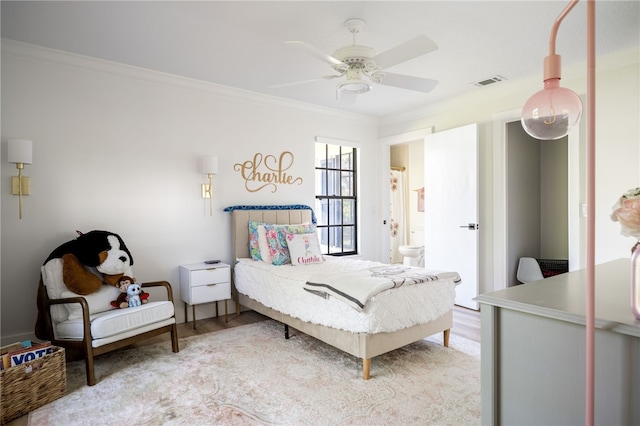 bedroom featuring crown molding, light hardwood / wood-style floors, and ceiling fan