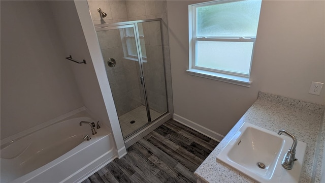 532 S Easy St, Sebastian, FL 32958 - bathroom featuring a shower stall, a bath, wood finished floors, vanity, and baseboards