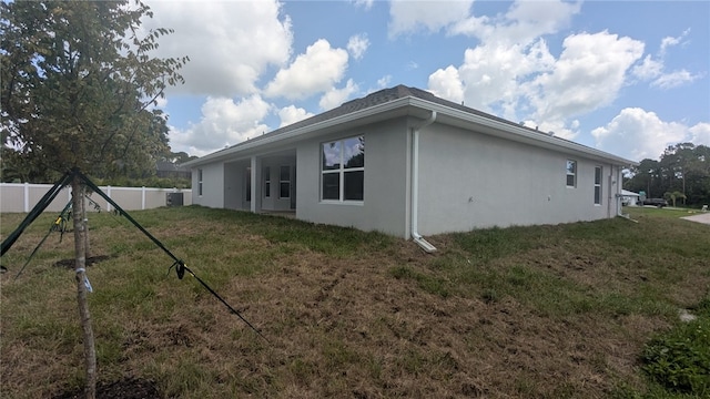 532 S Easy St, Sebastian, FL 32958 - rear view of property featuring stucco siding and central AC unit