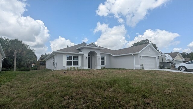 532 S Easy St, Sebastian, FL 32958 - single story home featuring an attached garage, stucco siding, concrete driveway, a front lawn, and roof with shingles