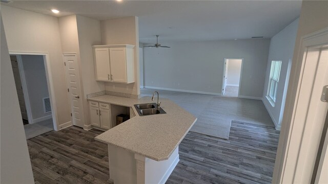 532 S Easy St, Sebastian, FL 32958 - kitchen featuring a sink, a peninsula, ceiling fan, white cabinets, and light countertops
