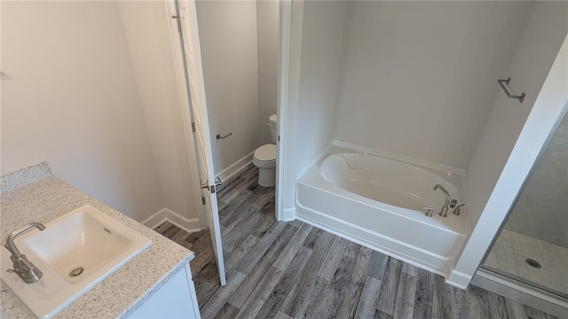 532 S Easy St, Sebastian, FL 32958 - bathroom with a garden tub, toilet, wood finished floors, vanity, and a shower stall