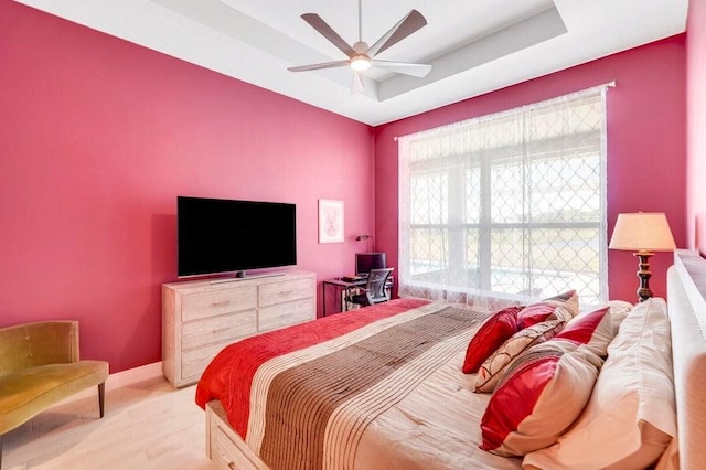 bedroom featuring ceiling fan and a tray ceiling