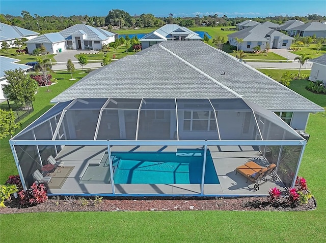 exterior space featuring a lanai, a patio area, and a lawn