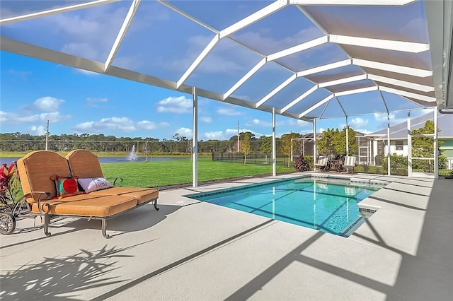 view of pool with a lawn, a patio area, a lanai, and a water view